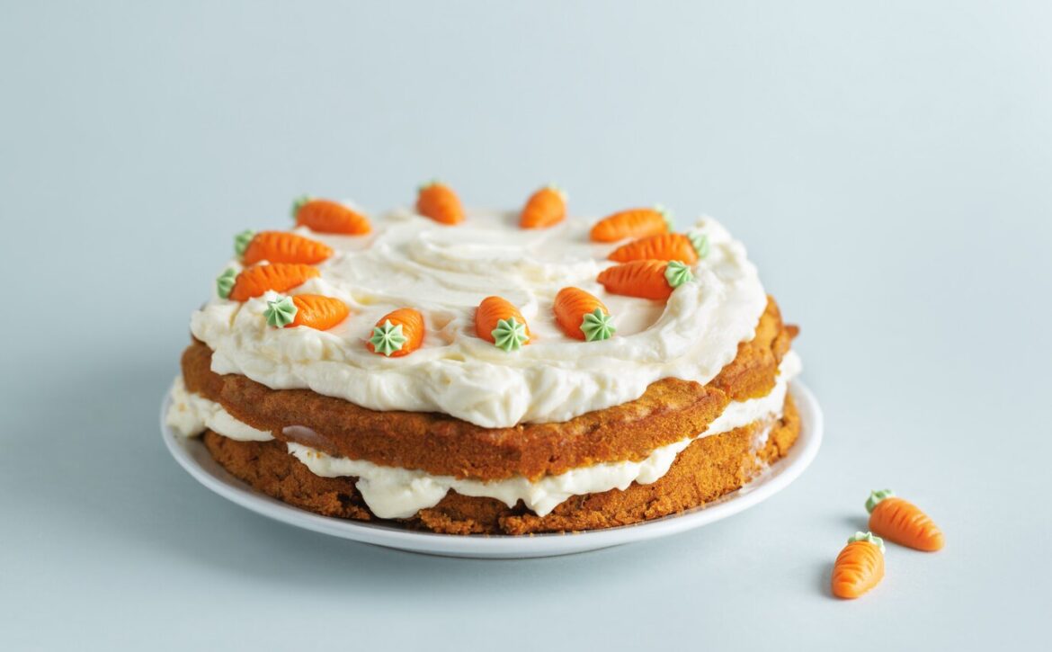 easter-carrot-cake-with-frosting-blue-background_1220-5219