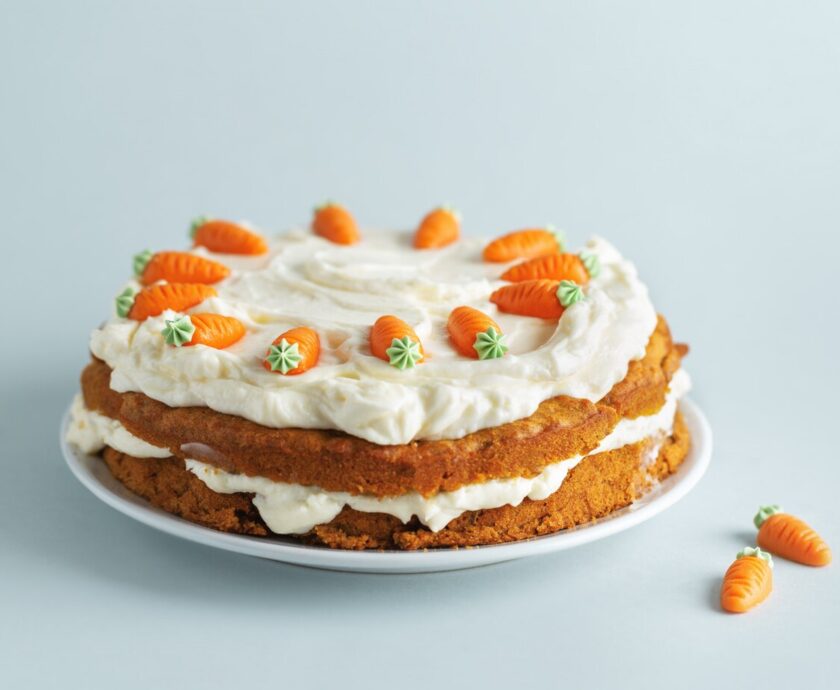 easter-carrot-cake-with-frosting-blue-background_1220-5219